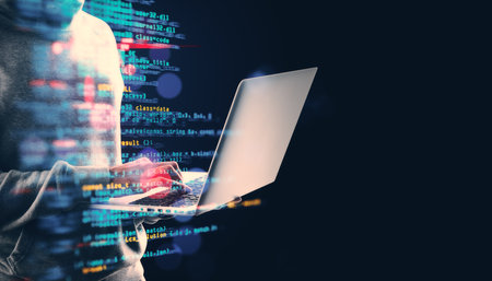 A person typing on a laptop, illuminated by colorful programming code on a dark background,...