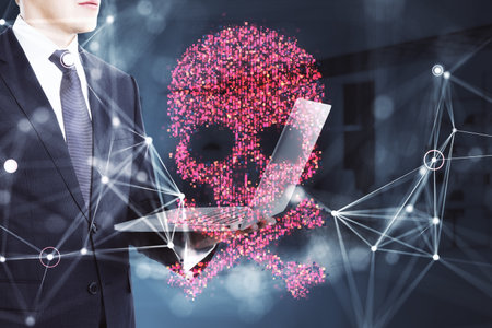 Businessman holding a laptop with a glowing red skull hologram. Abstract connections, dark background. Concept of cybersecurity and hacking. 3D Rendering.の写真素材