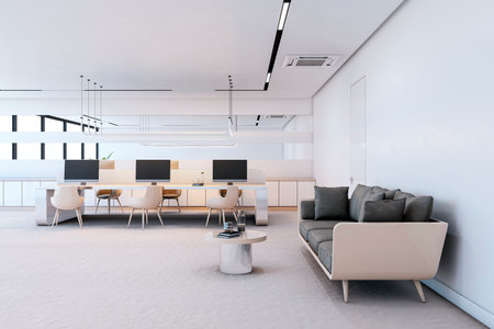 Contemporary office interior with desks, chairs, and a sofa in a light, spacious room, emphasizing...