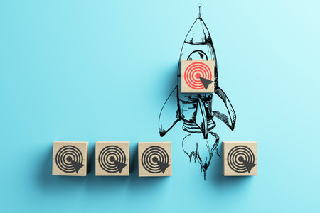 Wooden blocks featuring target icons - one block integrated into a rocket sketch on a light blue background. Concept of goals and success. 3D Rendering.の写真素材