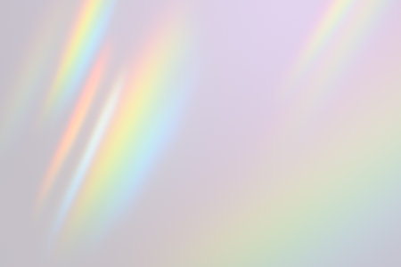 Abstract iridescent light streaks on a soft pastel gradient background. Subtle glow effect creating...