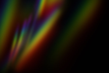 Blurred rainbow light leak effect on a dark background, creating a dreamy and vibrant abstract...