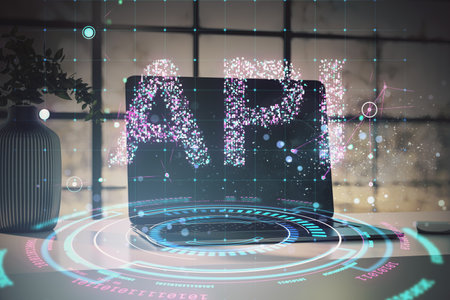 Digital API technology display with holographic elements on a laptop in a modern office setting....
