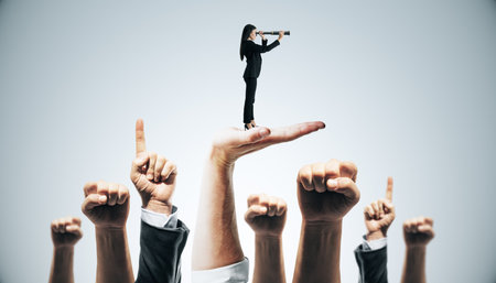 Businesswoman on hand looking through telescope, graphic style, light background, concept of leadership and visionの写真素材