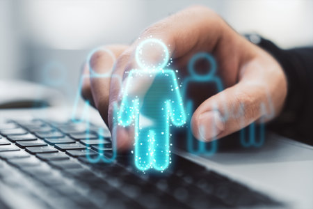 Hand selecting digital human icon on laptop keyboard, hologram style, on blurred background, concept of technology and hiringの写真素材
