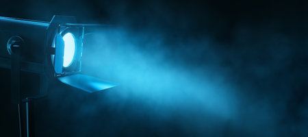 Theater spotlight emitting a blue beam through smoke on a dark background. 3D Renderingの写真素材