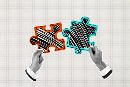 Two businessperson hands connecting sketched puzzle pieces on a light grid paper background, symbolizing teamwork and business collaboration conceptの写真素材