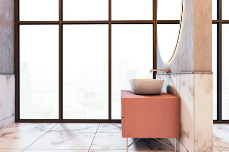 Modern bathroom with marble walls and floor, wooden vanity, round mirror, and large city view windows in daylight. 3D Renderingの写真素材