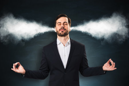 Businessman meditating with eyes closed, steam coming from ears, in abstract style on dark background, concept of stress relief and calmの写真素材