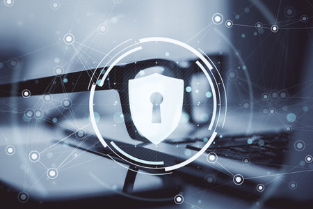 Shield lock icon with network lines overlaying glasses and laptop, in a creative light digital...