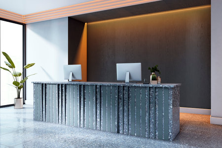 Stylish reception desk with terrazzo texture, two monitors, ambient ceiling lighting, and potted plants in a modern office lobby background. 3D Renderingの写真素材
