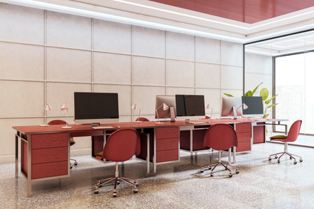 Contemporary office room with red desks and chairs, large desktop monitors, and bright lighting in a clean, modern interior. 3D Renderingの写真素材