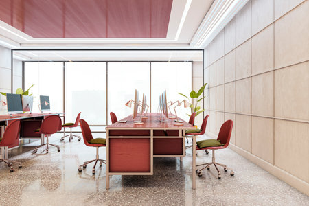 Modern office interior with red chairs, wooden desks, computers, and city view through large glass windows. 3D Renderingの写真素材