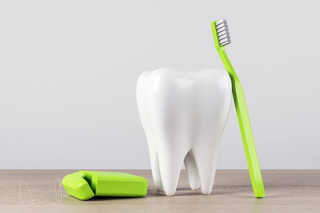 Tooth model, green toothbrush, and dental floss on wood table, light background. Dental hygiene and oral care concept. 3D Renderingの写真素材