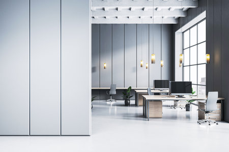 Contemporary office room with desks, chairs, and computers in clean modern design style, gray wall background, concept of business workspace. 3D Renderingの写真素材
