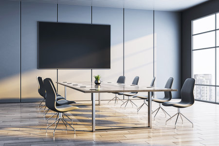 Contemporary business conference room with big TV display, stylish chairs and wooden desk on bright interior background. 3D Renderingの写真素材