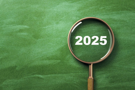 Magnifying glass showing 2025 on green chalkboard background, clean lighting, education and search concept with copyspace for design. 3D Renderingの写真素材