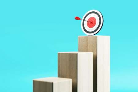 Wooden staircase steps with a dartboard target and arrow hit at center on blue gradient background. Concept of goal, growth, and business success. 3D Renderingの写真素材
