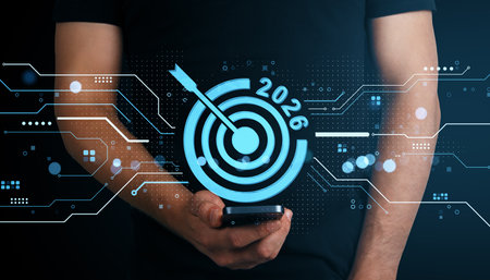 Man holding a smartphone with glowing digital target icon and 2026 text, blue neon interface on dark background, concept of future business goalsの写真素材