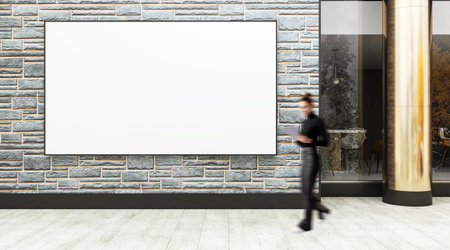 Empty white billboard on brick wall background with female figure walking by, street view in front of business building, concept of urban advertisingの写真素材