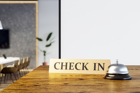 Hotel reception desk closeup with check-in sign and service bell, wooden counter, light interior, abstract office background. 3D Renderingの写真素材