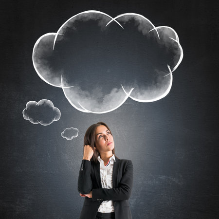 Woman in business suit thinking with speech bubbles above her head on dark background, concept of brainstorming and communicationの写真素材