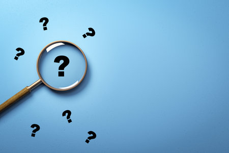 Magnifying glass focusing on a black question mark with scattered marks around on clean blue background, light shadow, concept of search and inquiry, 3D Renderingの写真素材