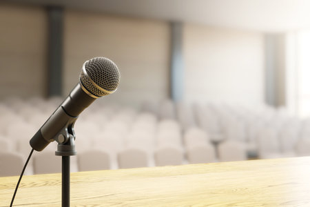 Closeup of microphone on stand placed on wooden podium, soft light background with blurred empty chairs, concept of public speaking. 3D Renderingの写真素材