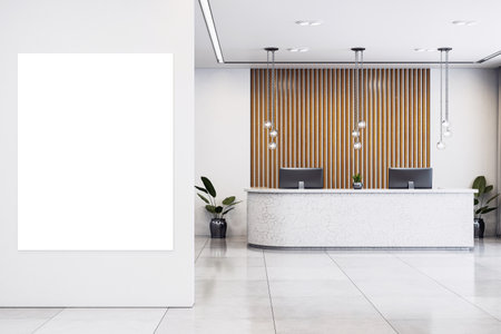 Vertical blank canvas on wall in modern corporate reception with clean white interior, marble desk, wood paneling and pendant lighting. 3D Renderingの写真素材