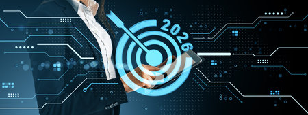 Business person holding tablet with 2026 target graphic overlay, futuristic tech style on dark background, representing goal planning and strategyの写真素材