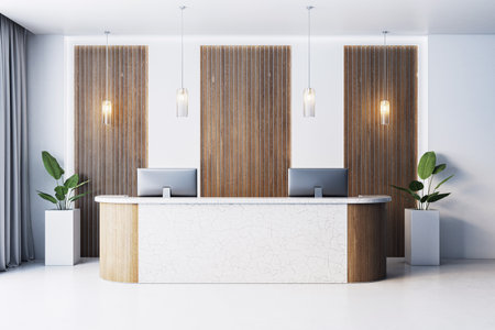 Contemporary office reception desk with marble and wood design, pendant lighting, vertical panels, and plants on clean indoor background. 3D Renderingの写真素材