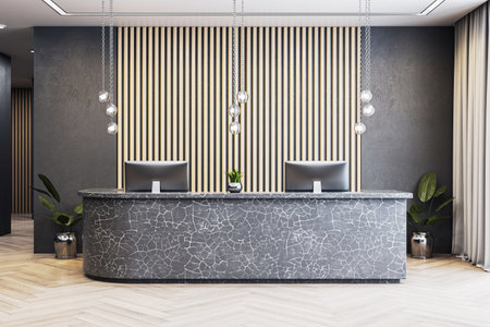 Stylish office reception with stone desk, computers, wood panel wall, hanging lights on parquet floor in modern corporate interior. 3D Renderingの写真素材