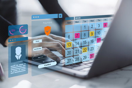 Person typing on laptop with digital calendar, payment form, and data interface on transparent screen in office workspace, futuristic tech conceptの写真素材