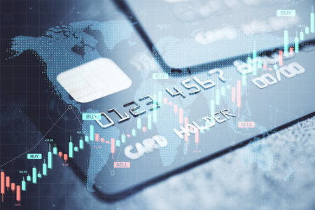 Closeup of a credit card with forex candlestick charts, financial data and global map in soft blur background, symbolizing digital trade economyの写真素材