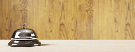 Metal service bell on light wooden desk, realistic style, with soft focus wooden wall background. Concept of hotel reception or office counter. 3D Renderingの写真素材
