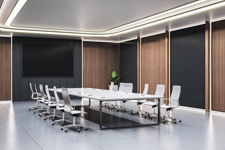 Spacious modern conference room with white table, executive chairs, wood panel walls, large display screen and soft ceiling lights. 3D Renderingの写真素材