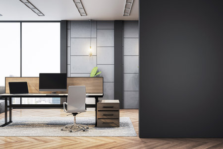Modern executive office interior with desk, chair, and computer in front of large blank dark wall, on wooden floor and city view. 3D Renderingの写真素材