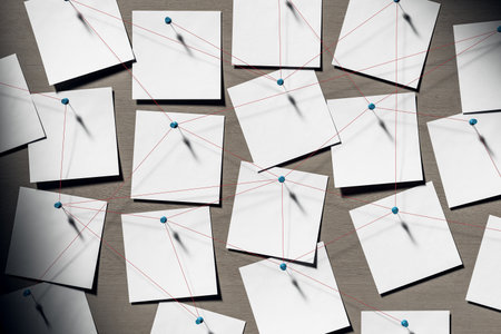 White blank notes pinned with blue tacks and connected by red threads on wooden background in soft light, symbol of detective work or brainstorming. 3D Renderingの写真素材