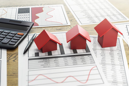 Red house models, charts, calculator, and pen on wood background showing real estate market analysis and property investment concept. 3D Renderingの写真素材