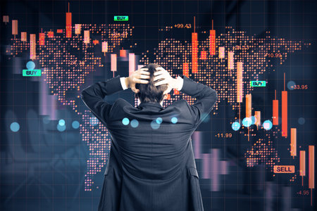 Businessman seen from rear stressed by financial loss, with red market chart and global map on dark background, symbolizing economic crisisの写真素材
