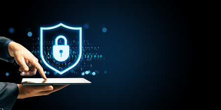 Hand using tablet with glowing padlock shield hologram, futuristic digital style on dark background,...