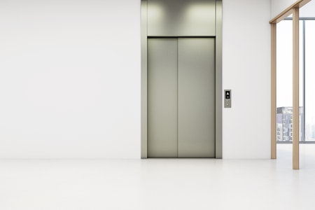 Closed elevator doors in a modern empty hallway with blank white wall, minimalist interior, and cityscape background. 3D Renderingの写真素材