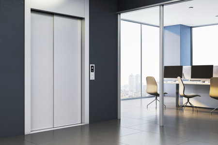 Closed elevator doors inside a modern corporate office building, with a glass-walled room and...