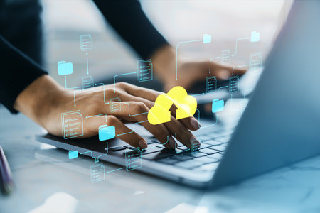 Person typing on laptop with cloud upload and digital document icons, in modern office background,...