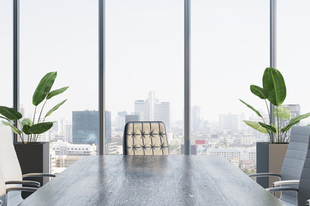 Modern corporate boardroom interior with wooden desk, executive chairs, large windows, cityscape background, and green plants. 3D Renderingの写真素材