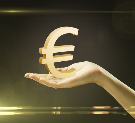 3d Gold Euro Sign on a woman's handの写真素材