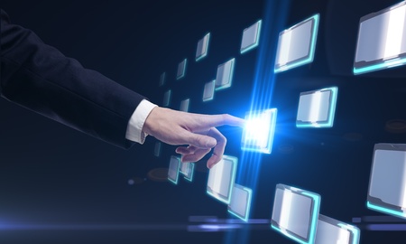 Young business man pressing a touchscreen buttonの写真素材