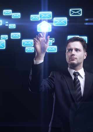  Young business man pressing a envelope touchscreen buttonの写真素材
