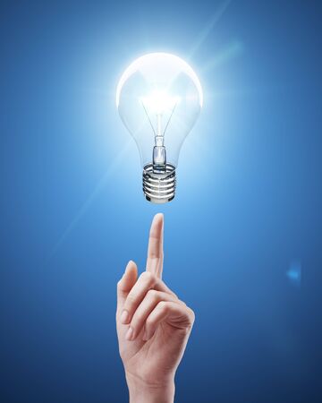 woman's hand points to drawing  lampの写真素材