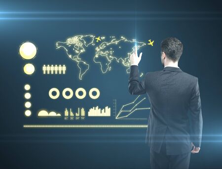 man pressing a touchscreen global communications buttonの写真素材